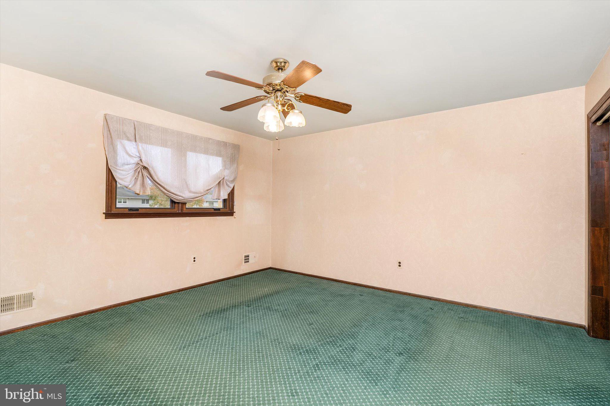 87 Limewood Drive Hamilton, NJ 08690 - Photo 25 of 34 an empty room with a window and a ceiling fan