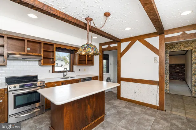 a kitchen with stainless steel appliances kitchen island granite countertop a sink and cabinets