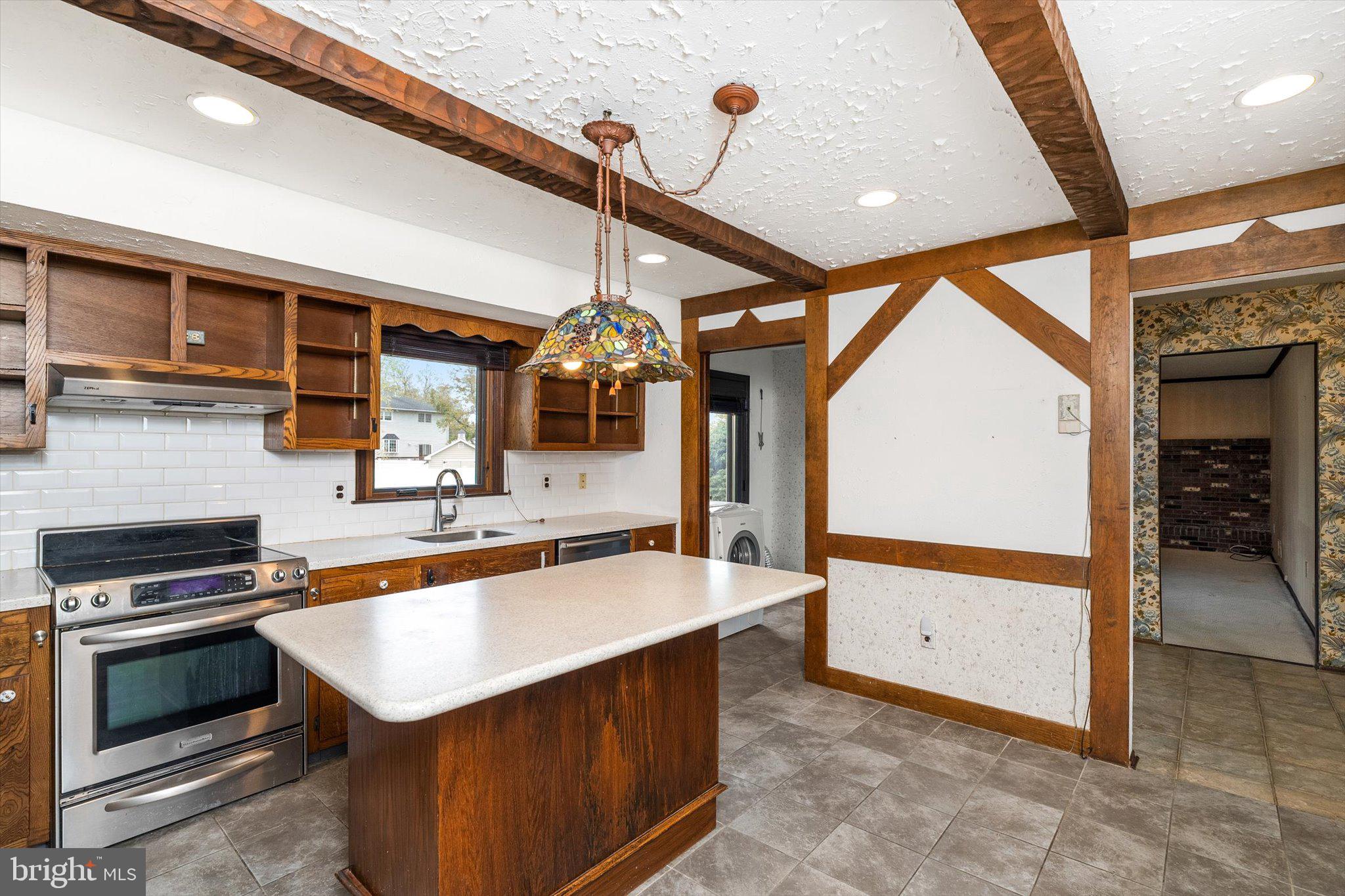 87 Limewood Drive Hamilton, NJ 08690 - Photo 5 of 34 a kitchen with stainless steel appliances kitchen island granite countertop a sink and cabinets