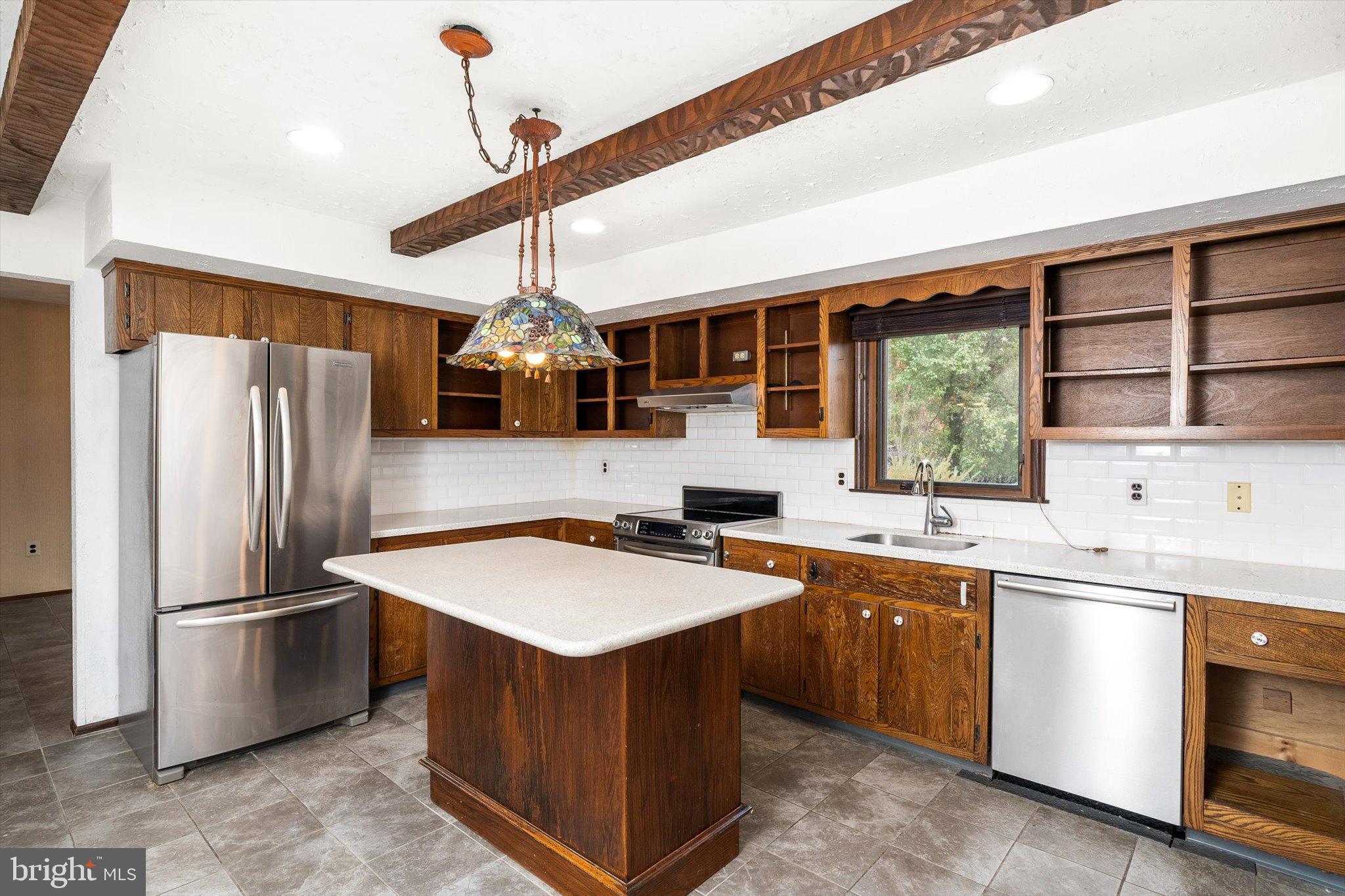 87 Limewood Drive Hamilton, NJ 08690 - Photo 6 of 34 a kitchen with stainless steel appliances a sink stove and refrigerator