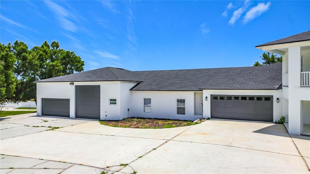 7925 Lake Mabel Loop Road Lake Wales, FL 33898 - Photo 5 of 97 a front view of a house with a yard and garage