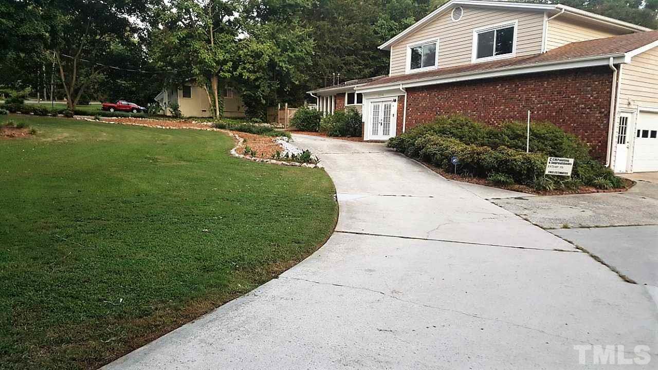 3204 Timberlake Road Raleigh, NC 27604 - Photo 1 of 25 a front view of a house with a yard and potted plants