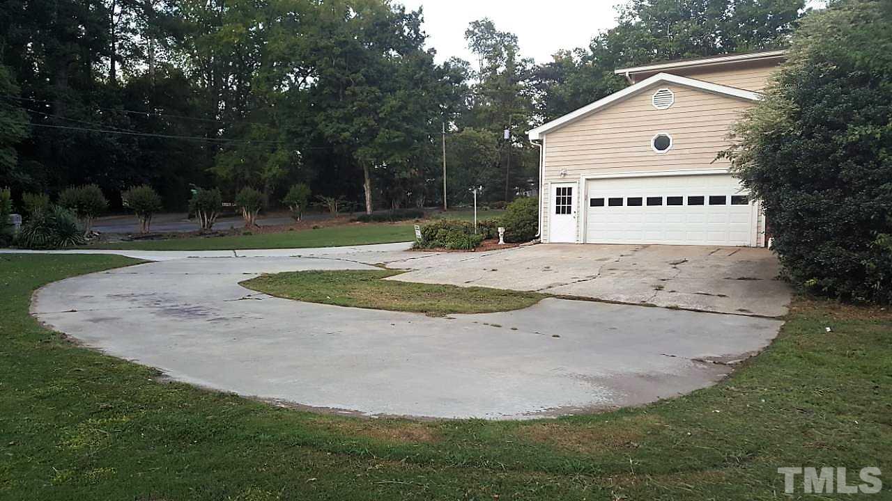 3204 Timberlake Road Raleigh, NC 27604 - Photo 3 of 25 a view of a house with backyard and trees