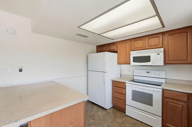 a kitchen with a white cabinets and white appliances