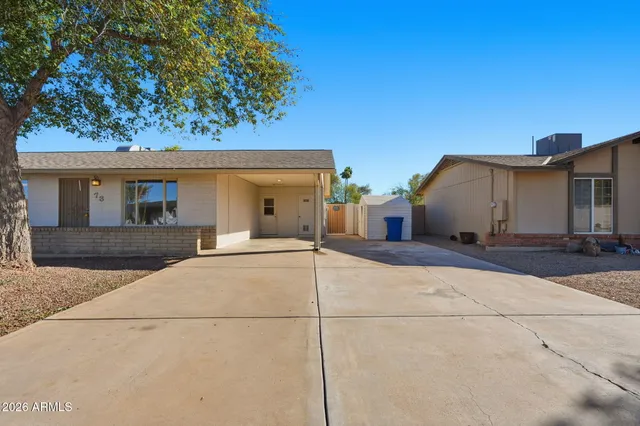 a view of a house with a backyard and a garage