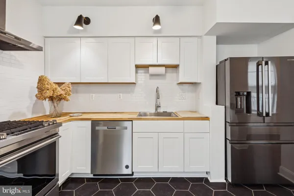 a kitchen with a sink appliances and cabinets