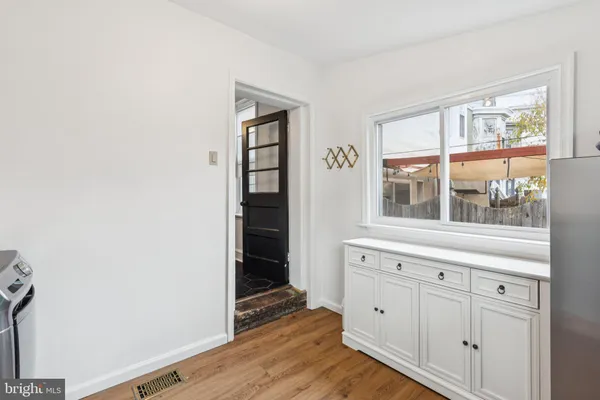a view of wooden floor and windows in a room