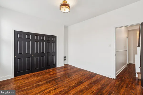 an empty room with wooden floor