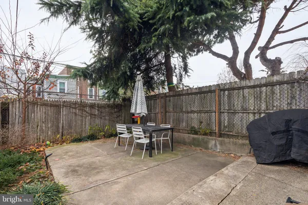 a view of a chairs and tables in the back yard of the house