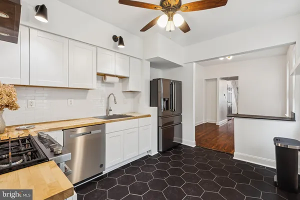 a kitchen with stainless steel appliances a stove a refrigerator and cabinets
