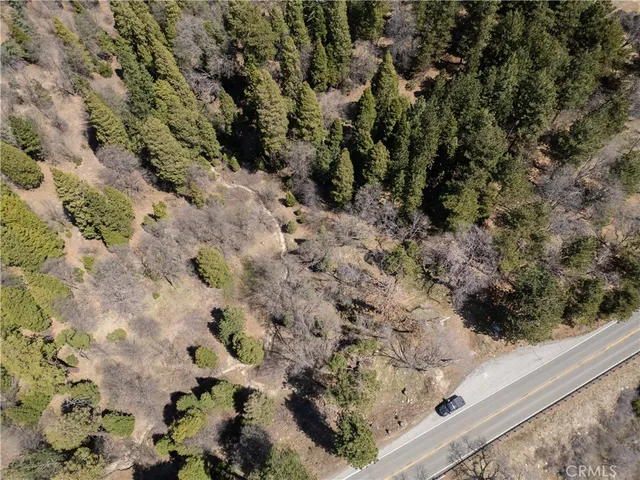 a view of a yard with a wooden fence