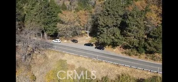 a view of a yard with wooden fence