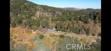 a view of a dry yard with mountains