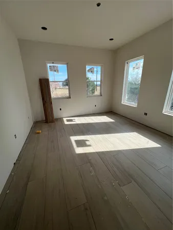 a view of a livingroom with wooden floor and window