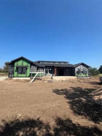 a yellow house with trees in front of it