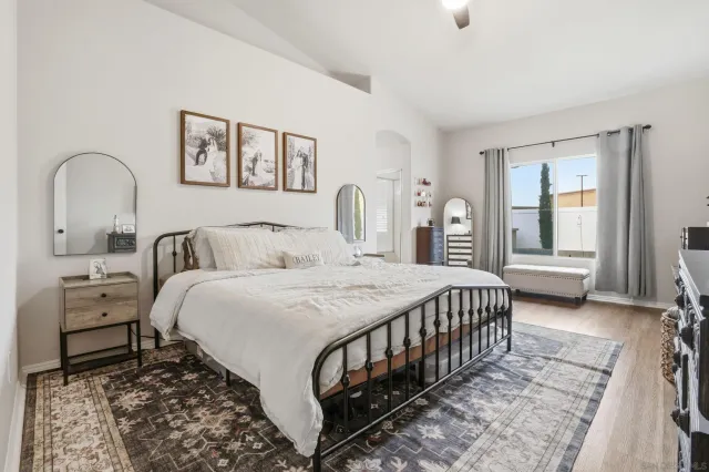 a bedroom with a bed and a large window