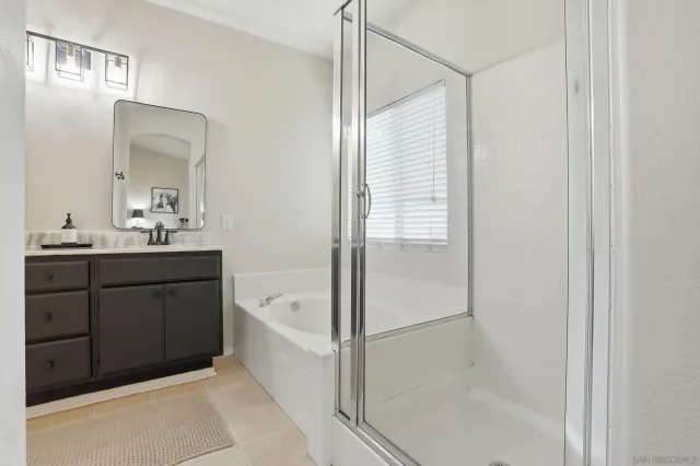 a bathroom with a tub sink and mirror