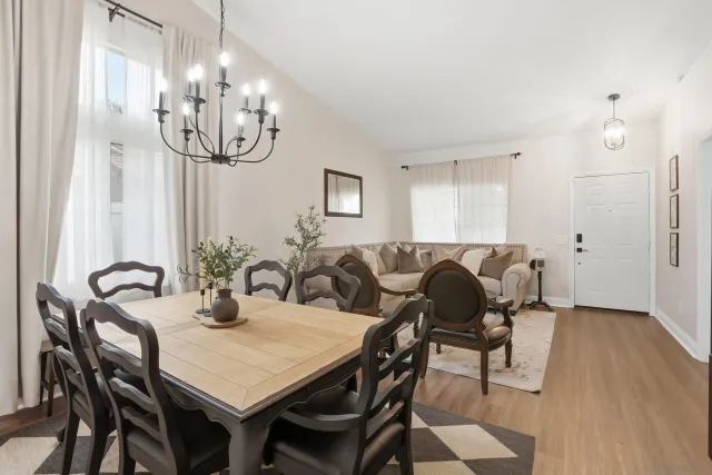 a view of a dining room with furniture and chandelier