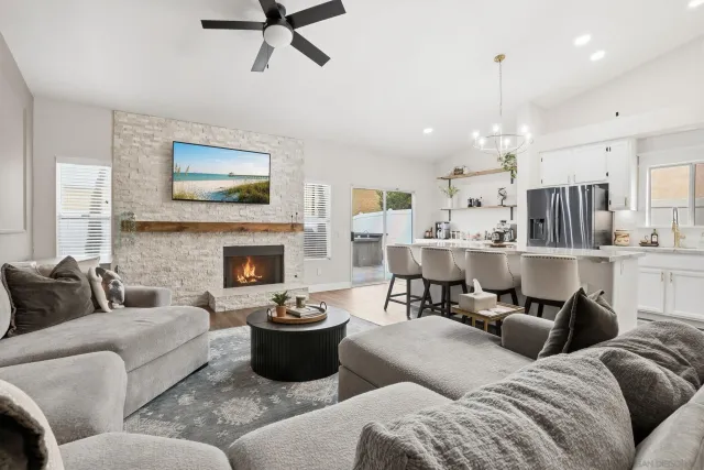 a living room with furniture kitchen view and a fireplace