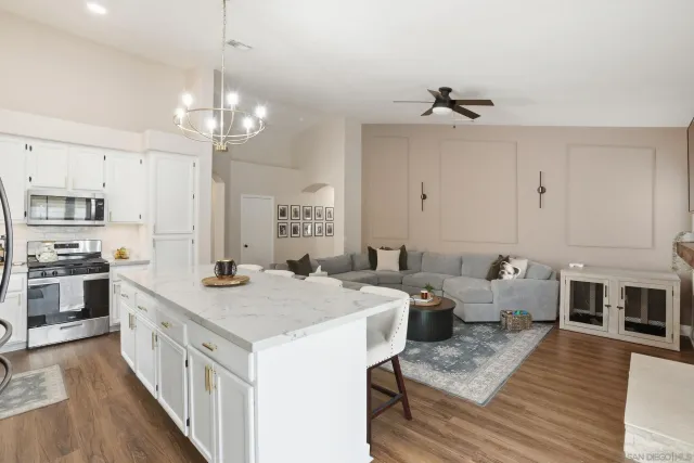a open kitchen with stainless steel appliances granite countertop a sink stove and refrigerator