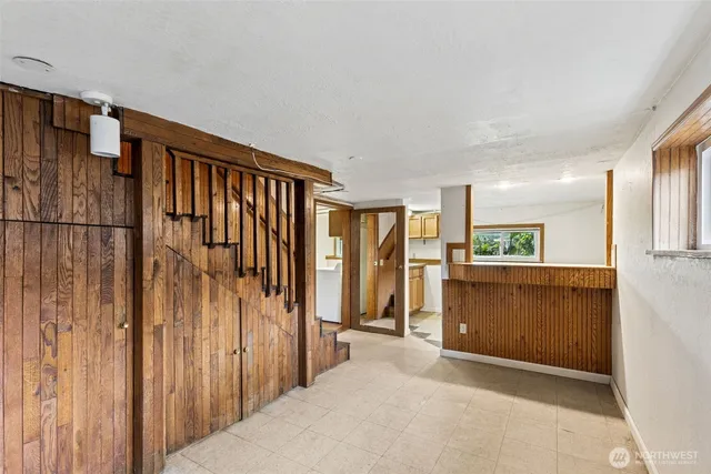 a view of hallway with furniture and a refrigerator