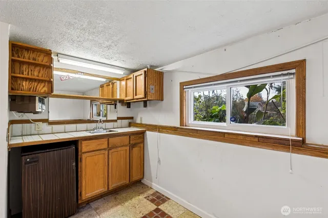 a kitchen with a sink and large window