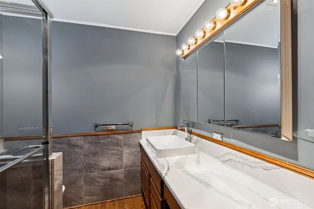 a bathroom with a granite countertop sink and a mirror