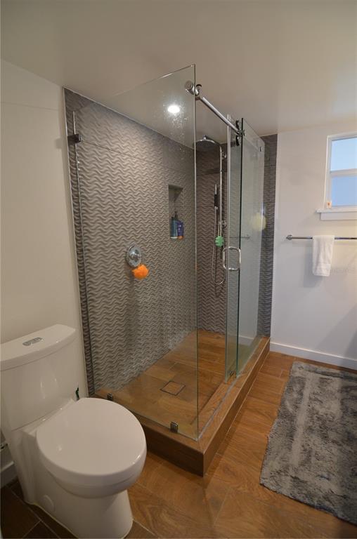 4420 Exeter Drive, Unit 208 Longboat Key, FL 34228 - Photo 11 of 28 a bathroom with a shower and a toilet