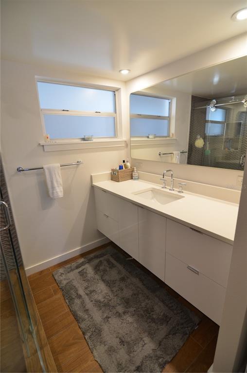4420 Exeter Drive, Unit 208 Longboat Key, FL 34228 - Photo 12 of 28 a room with a sink a mirror and a vanity