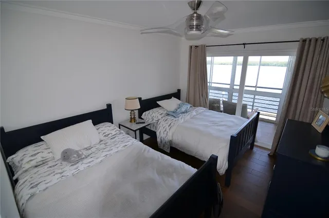 a bed sitting in a bedroom next to a window