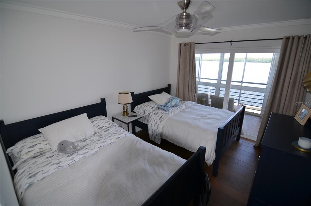 4420 Exeter Drive, Unit 208 Longboat Key, FL 34228 - Photo 14 of 28 a bed sitting in a bedroom next to a window