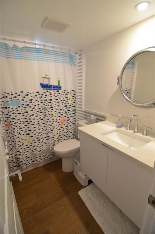 4420 Exeter Drive, Unit 208 Longboat Key, FL 34228 - Photo 15 of 28 a bathroom with a sink toilet and a mirror