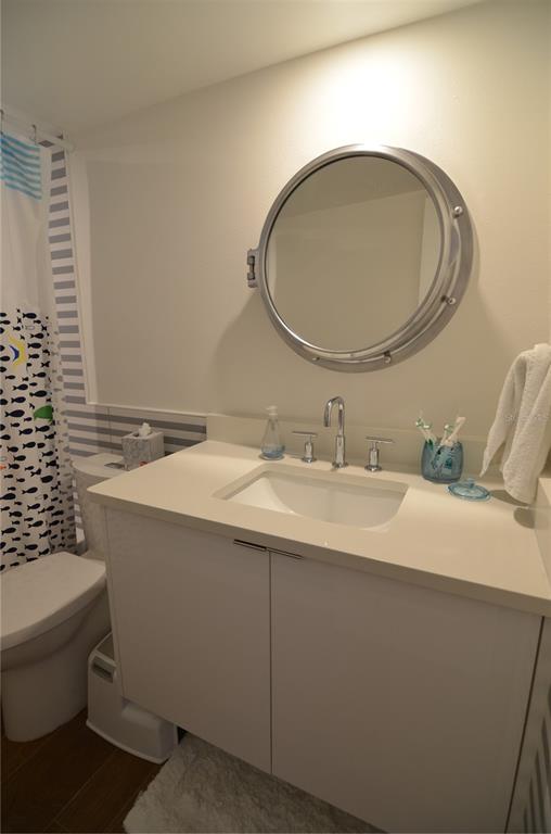 4420 Exeter Drive, Unit 208 Longboat Key, FL 34228 - Photo 16 of 28 a bathroom with a sink and a mirror