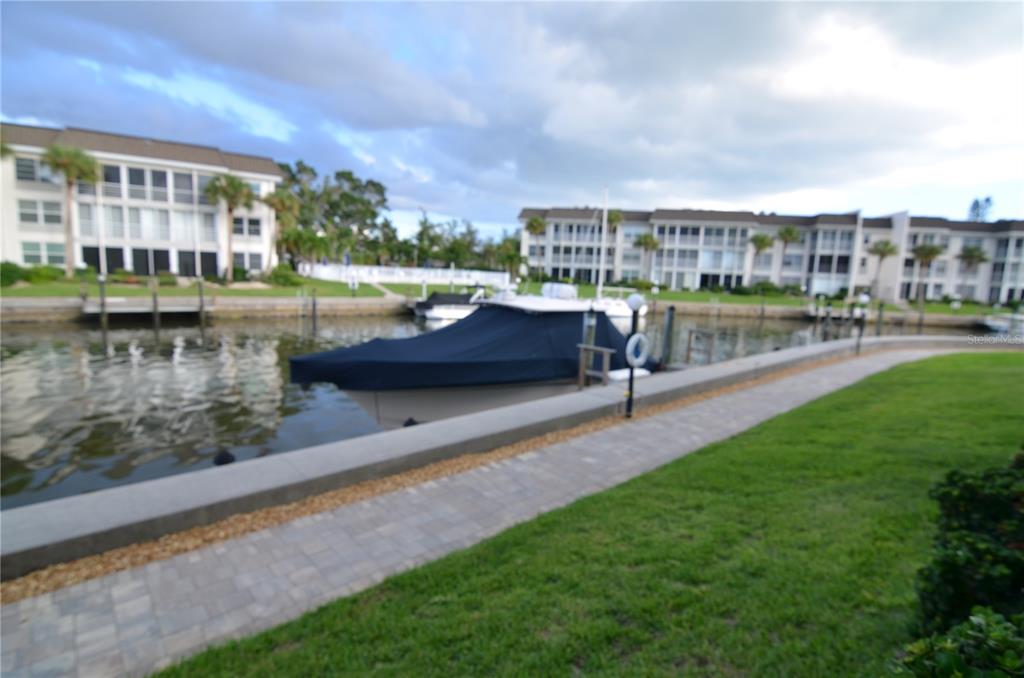 4420 Exeter Drive, Unit 208 Longboat Key, FL 34228 - Photo 19 of 28 a view of a lake from a building and outdoor space