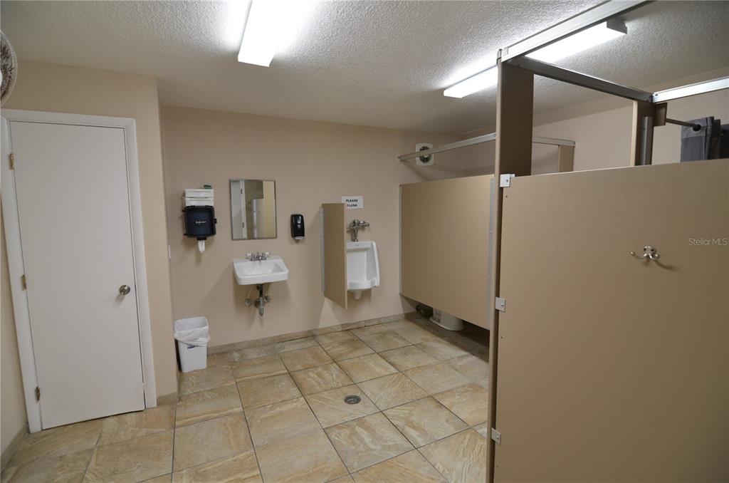 4420 Exeter Drive, Unit 208 Longboat Key, FL 34228 - Photo 28 of 28 a bathroom with a sink a toilet and a mirror