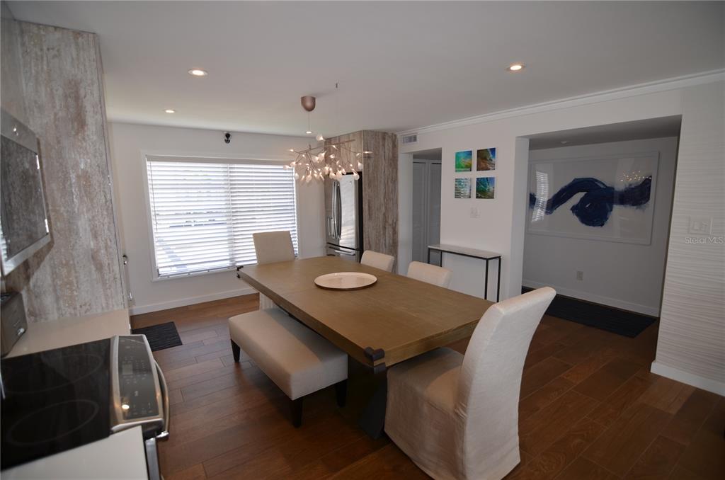 4420 Exeter Drive, Unit 208 Longboat Key, FL 34228 - Photo 7 of 28 a view of a dining room with furniture and wooden floor