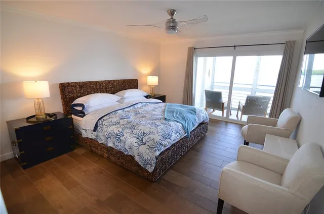 a bedroom with bed and a large window