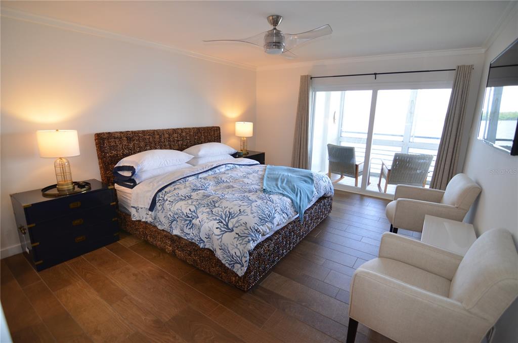4420 Exeter Drive, Unit 208 Longboat Key, FL 34228 - Photo 8 of 28 a bedroom with bed and a large window