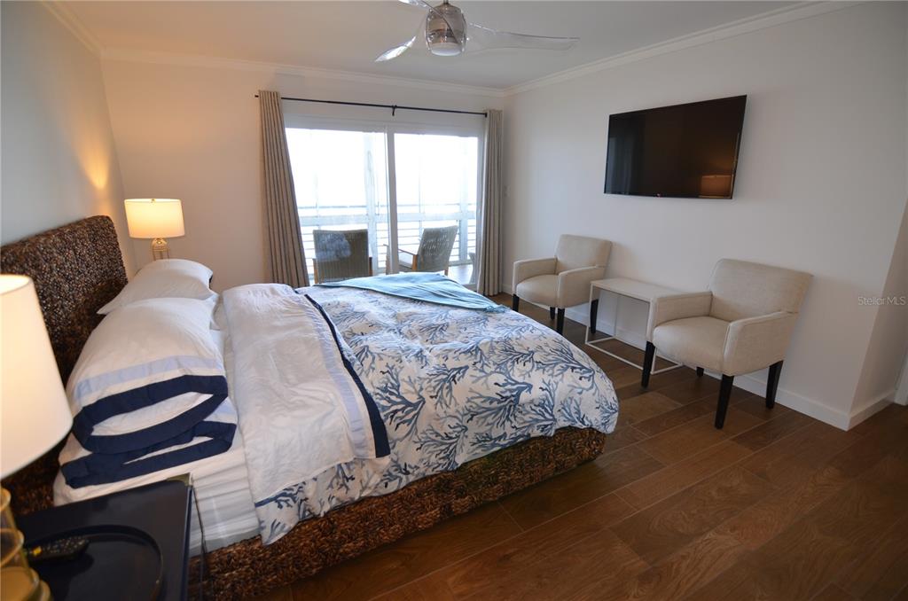 4420 Exeter Drive, Unit 208 Longboat Key, FL 34228 - Photo 9 of 28 a bedroom with a bed and a flat screen tv