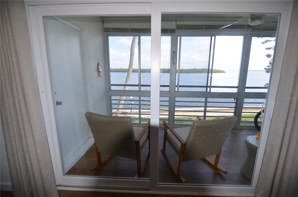 4420 Exeter Drive, Unit 208 Longboat Key, FL 34228 - Photo 10 of 28 a view of a dining room with furniture and window