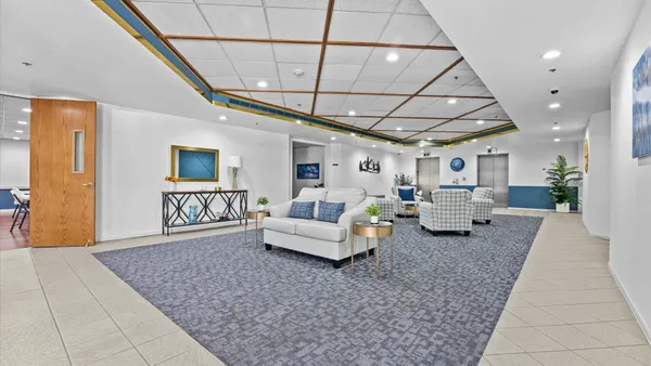 a living room with furniture and a rug