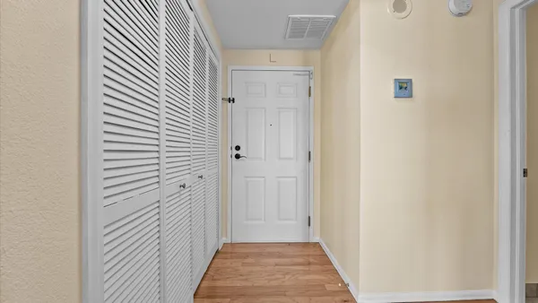 a view of a hallway with wooden floor