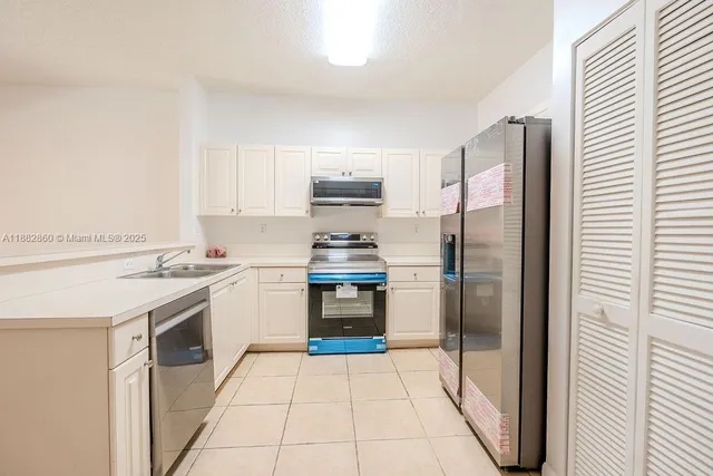 a kitchen with a refrigerator sink and stove
