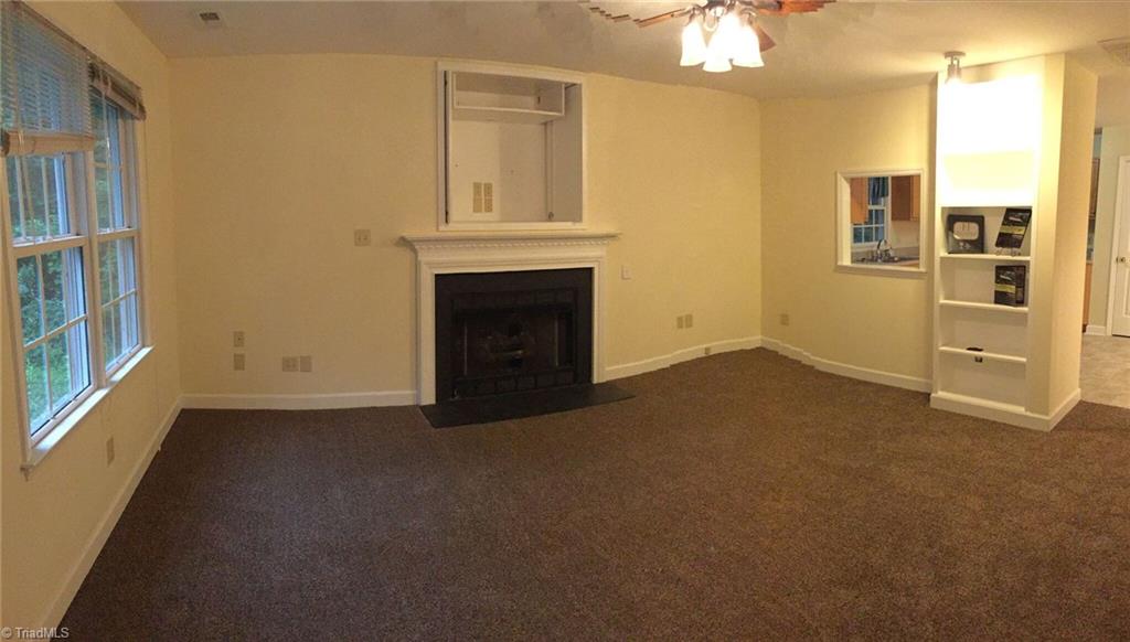 321 Burton Road Advance, NC 27006 - Photo 3 of 29 Living Room with new carpet, fireplace with TV niche above, and built-in for display