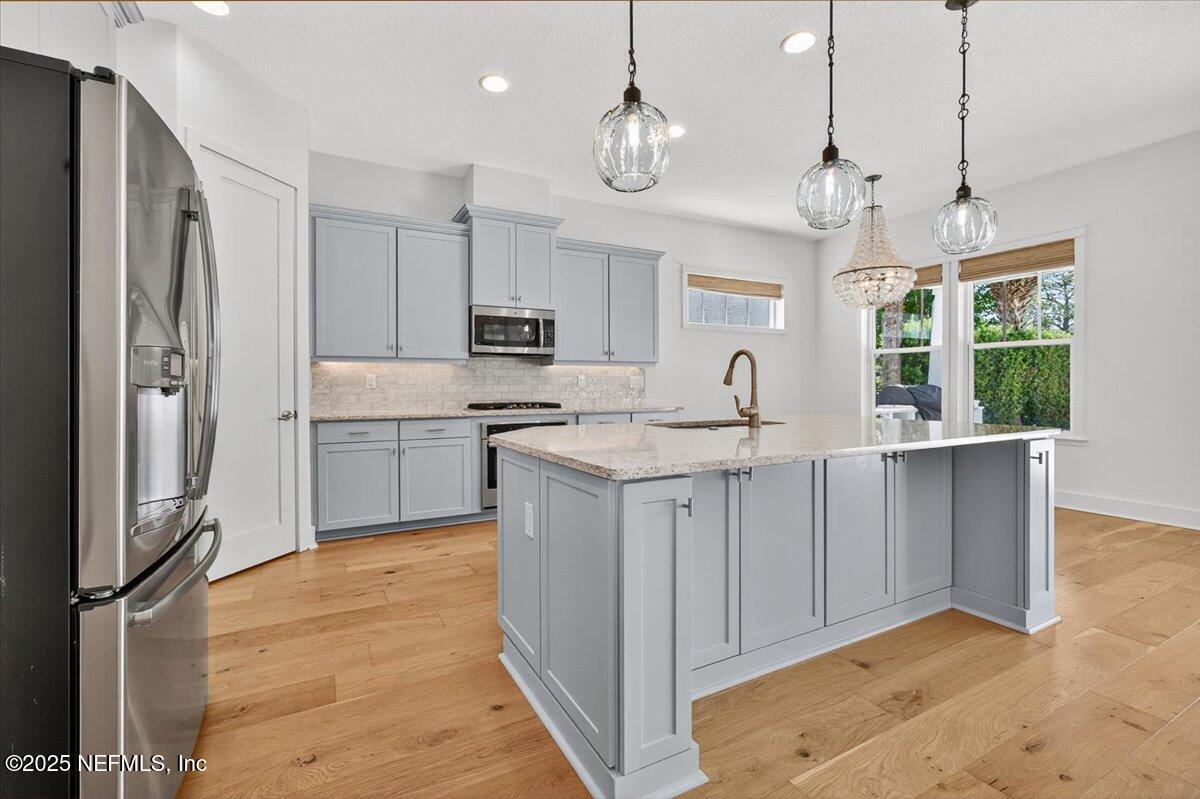 604 Timber Bridge Lane Atlantic Beach, FL 32233 - Photo 15 of 46 a kitchen with kitchen island granite countertop a stove a sink a refrigerator and a granite counter tops