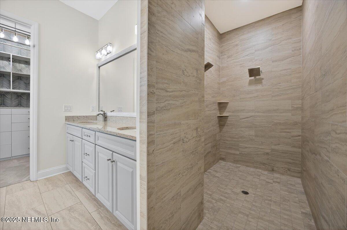 604 Timber Bridge Lane Atlantic Beach, FL 32233 - Photo 18 of 46 a bathroom with a granite countertop sink a shower and a mirror