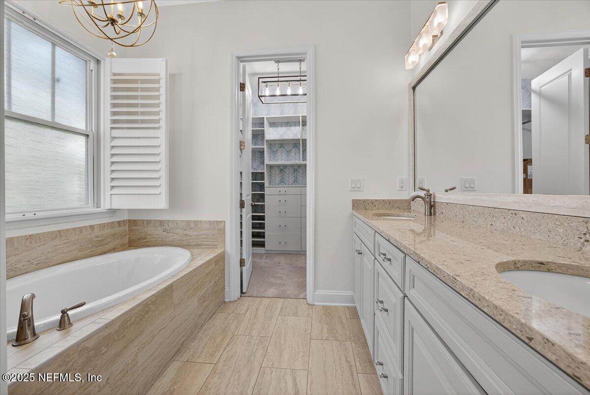 604 Timber Bridge Lane Atlantic Beach, FL 32233 - Photo 20 of 46 a bathroom with a granite countertop tub a sink and a large window
