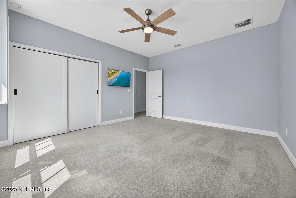 604 Timber Bridge Lane Atlantic Beach, FL 32233 - Photo 25 of 46 an empty room with closet and ceiling fan