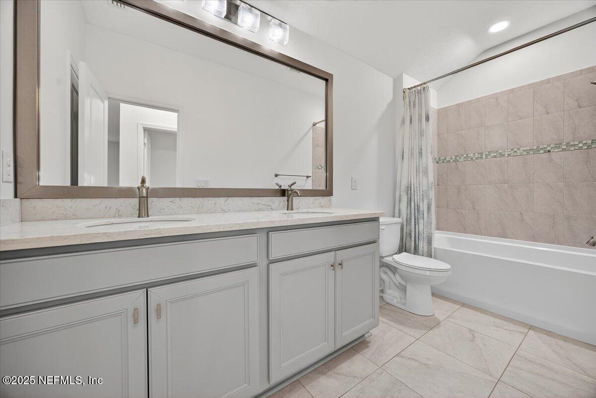 604 Timber Bridge Lane Atlantic Beach, FL 32233 - Photo 26 of 46 a bathroom with a granite countertop sink a toilet and a mirror