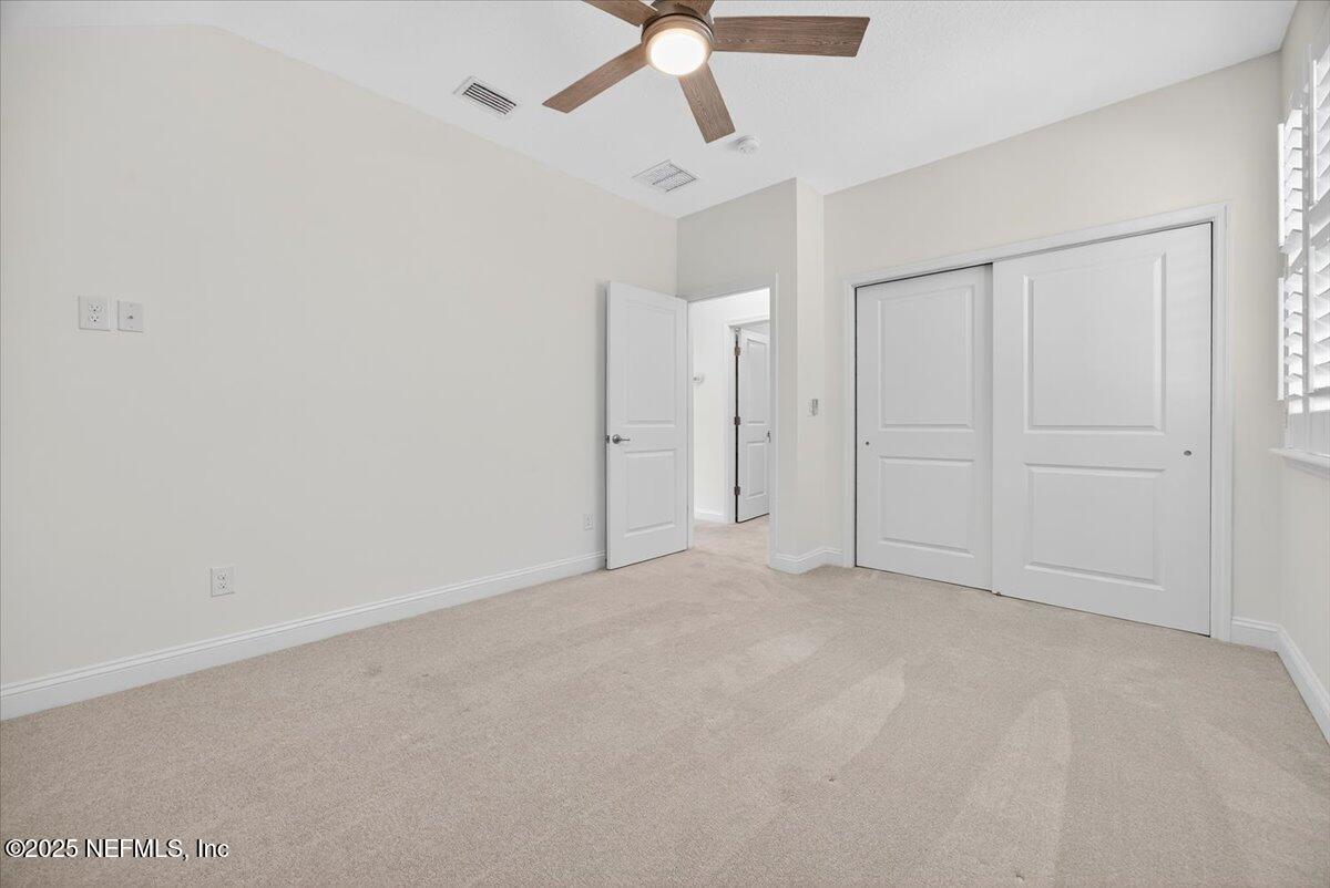 604 Timber Bridge Lane Atlantic Beach, FL 32233 - Photo 28 of 46 an empty room with chandelier fan